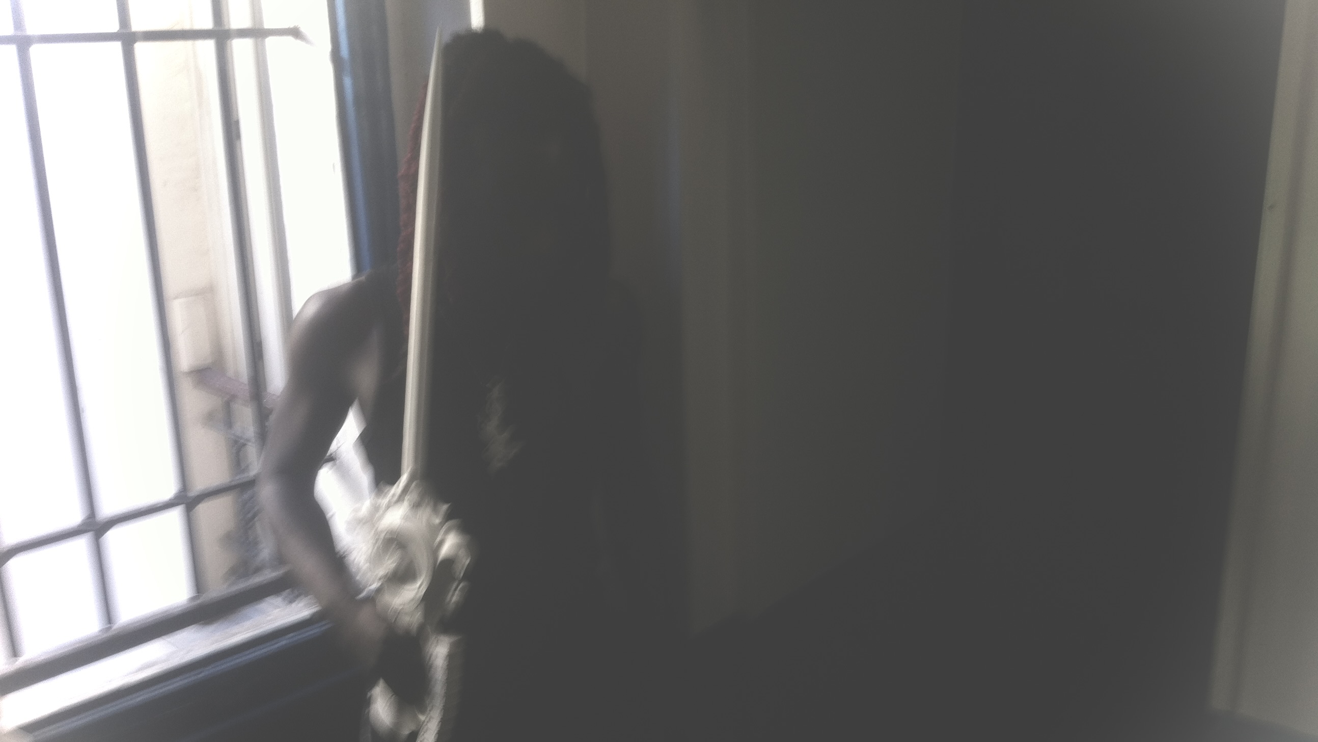 Portrait beside a window with a white sculptural object