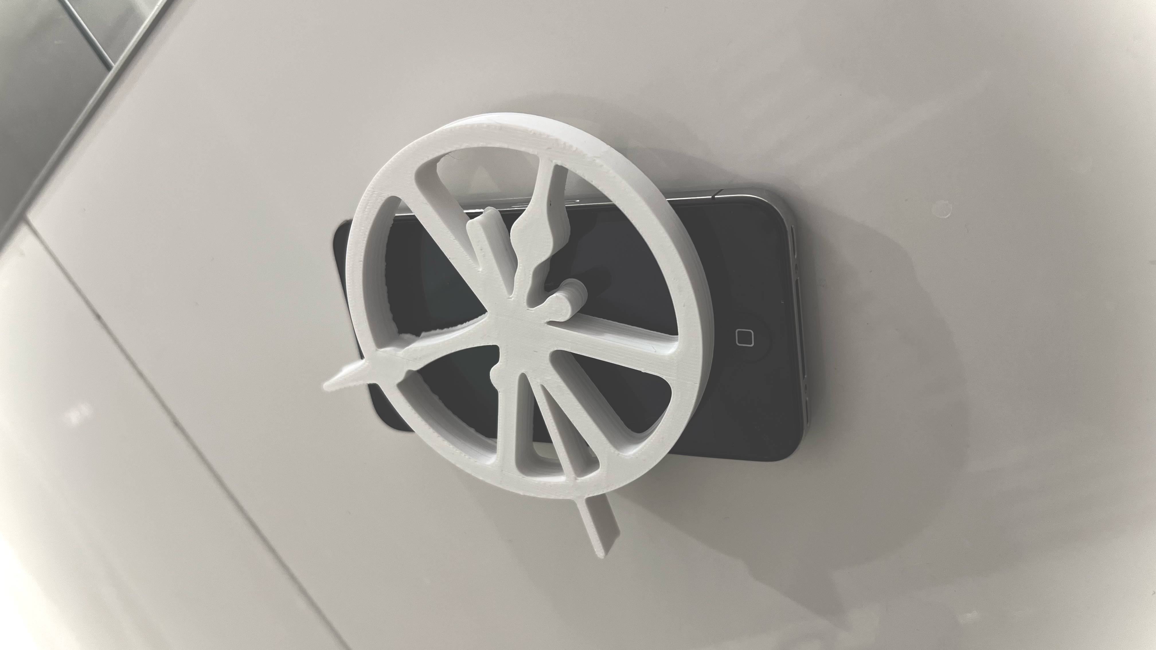 White peace and clock symbol resting on a phone, first view
