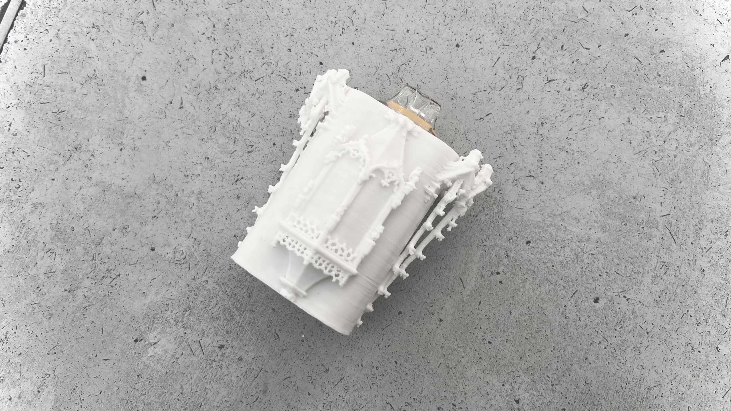 White architectural holder resting on a grey surface